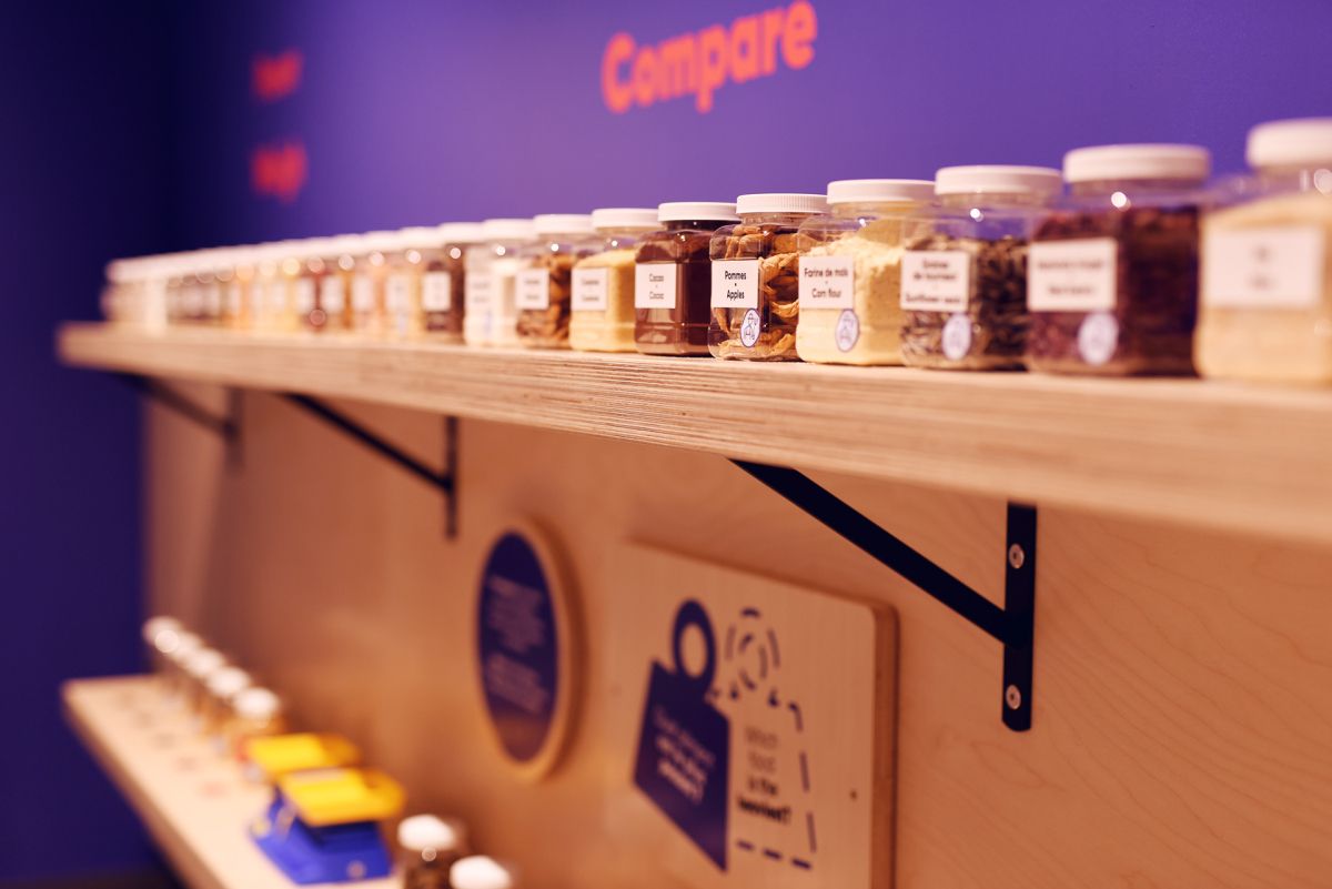 A diverse range of spices sits on a shelf at the Mini Mondo exhibition